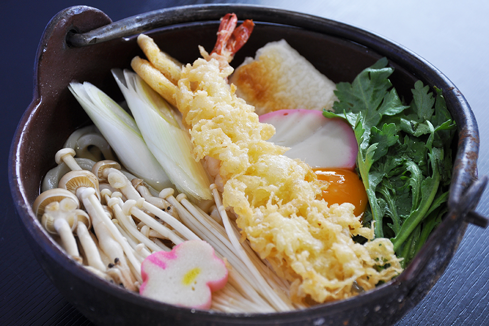 調理前の「天ぷら鍋焼きうどん」。実際にはぐつぐつ煮込んでから提供されます。（1210円・税込）